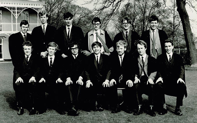 University students pose for a group photograph outside their halls of residence