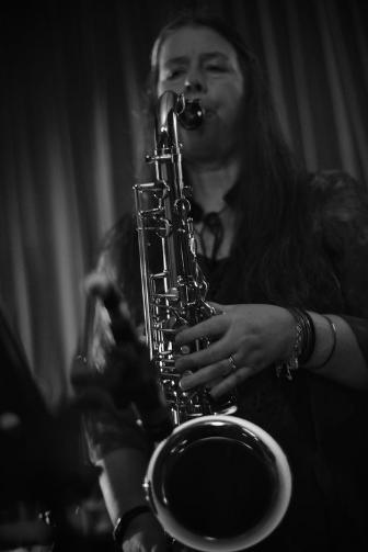 B/W photo of woman playing saxophone