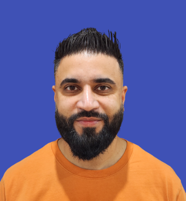 bearded man in orange shirt with blue background
