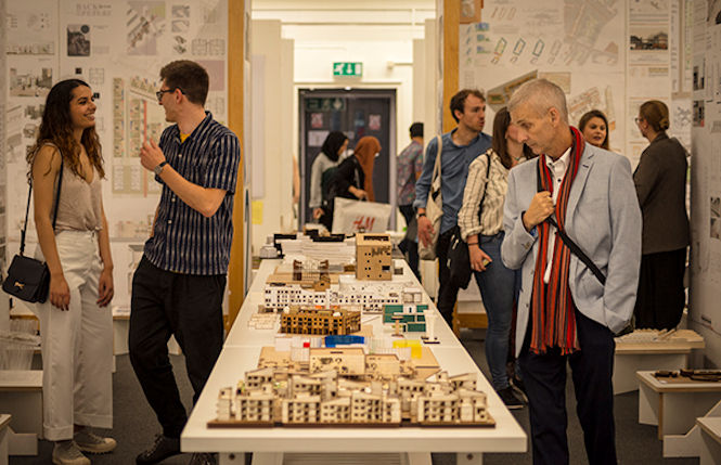 A man looking at Architecture students model work