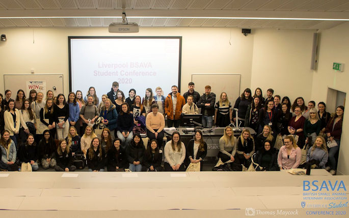 A large group of students gather in a lecture hall after the BSAVA student conference