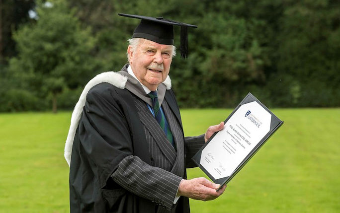 Alumnus Philip Ayrton-Grime holding his honorary degree certificate