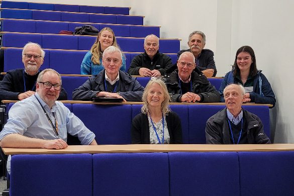 Group photo of graduates sitting in a lecture theatre