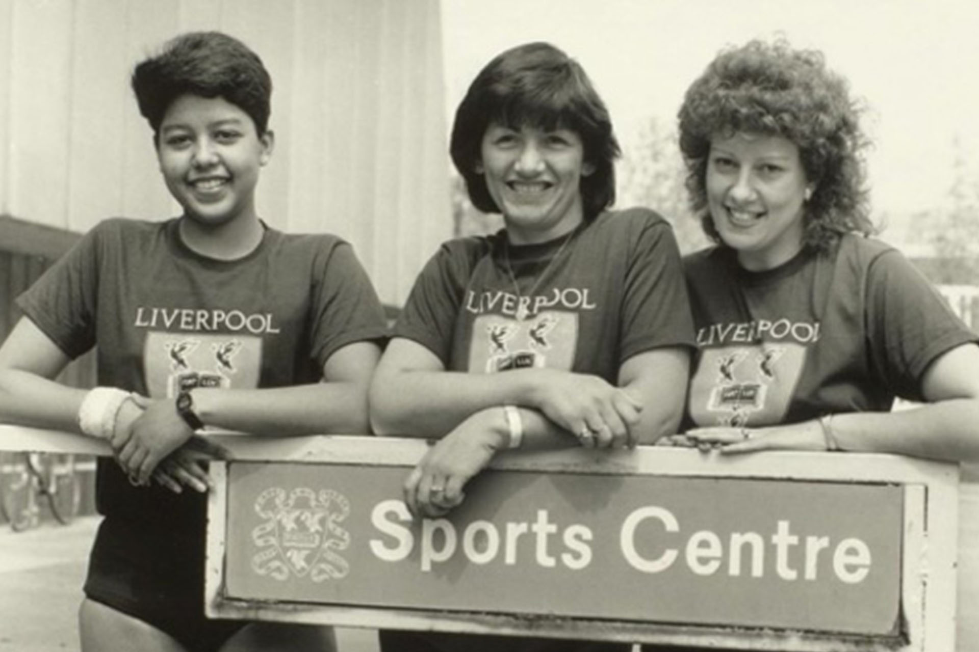 group of people outside a sports centre in the 1970s