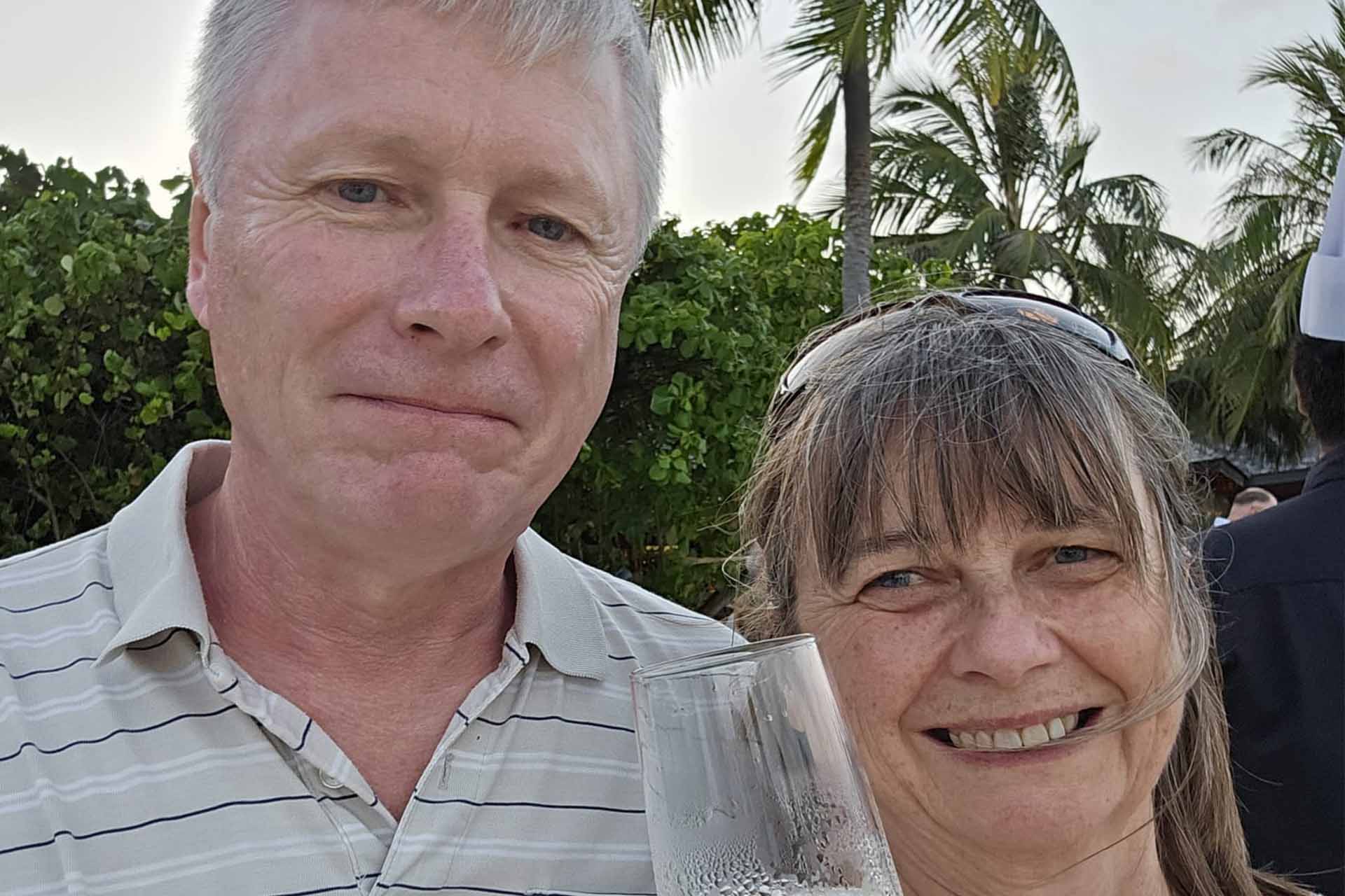 Two people pose for a photo on holiday