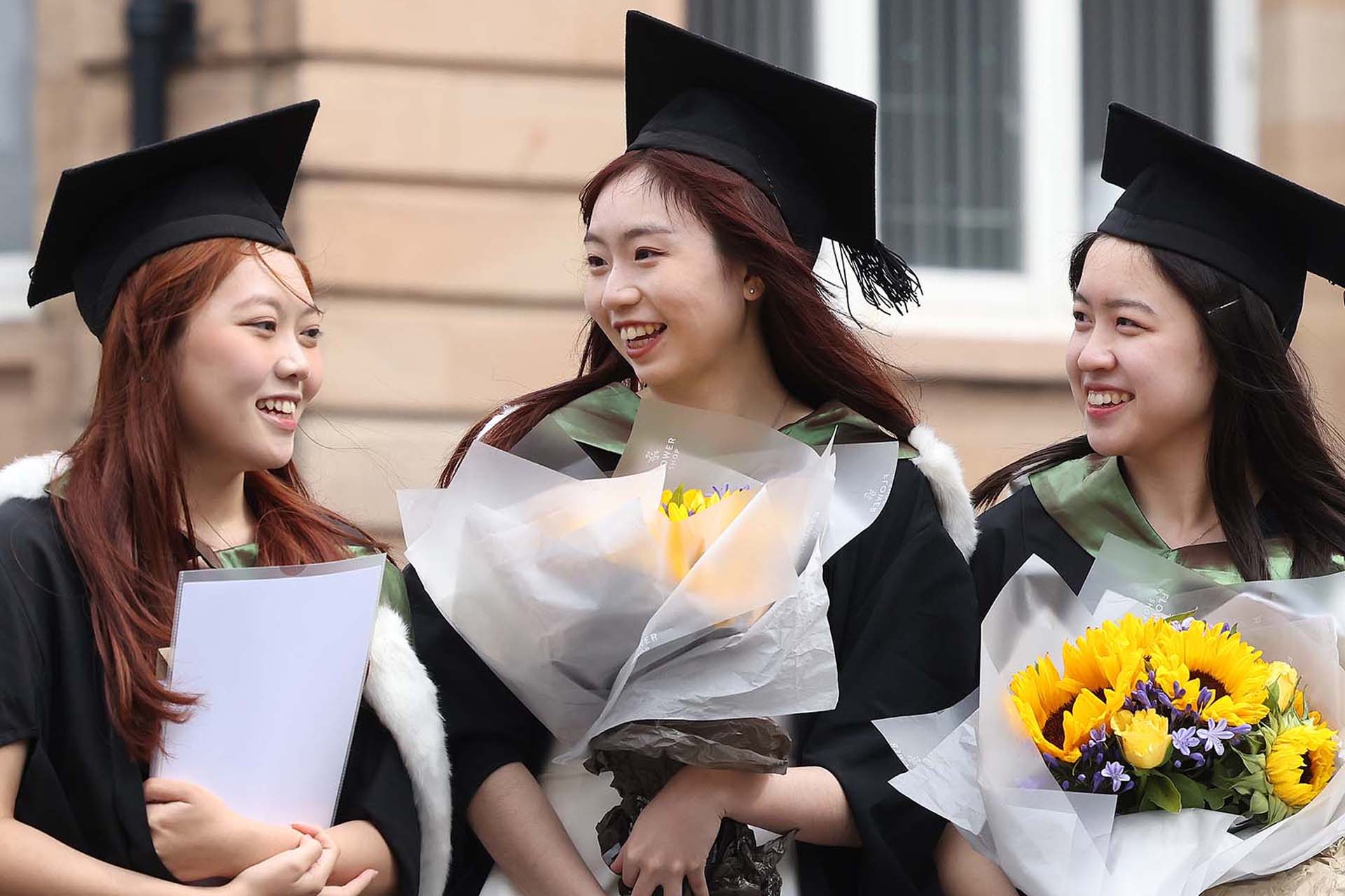 three people at their graduation