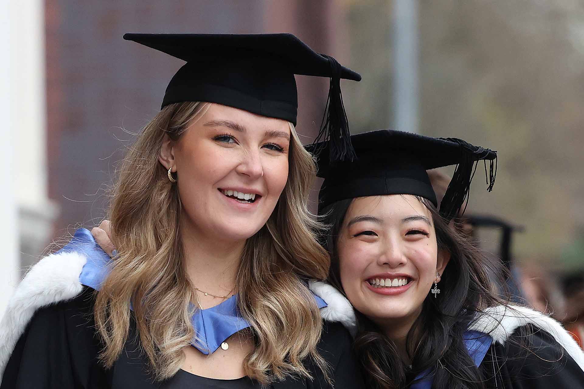 Two students smiling at their graduation