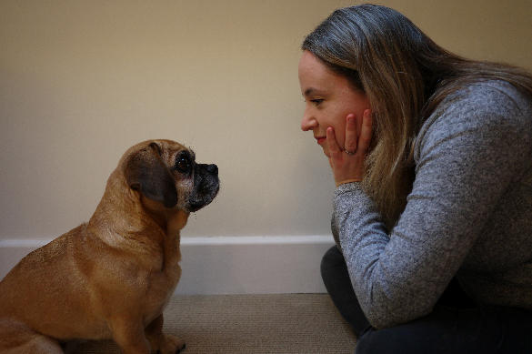 Carri and her dog in profile looking at each other