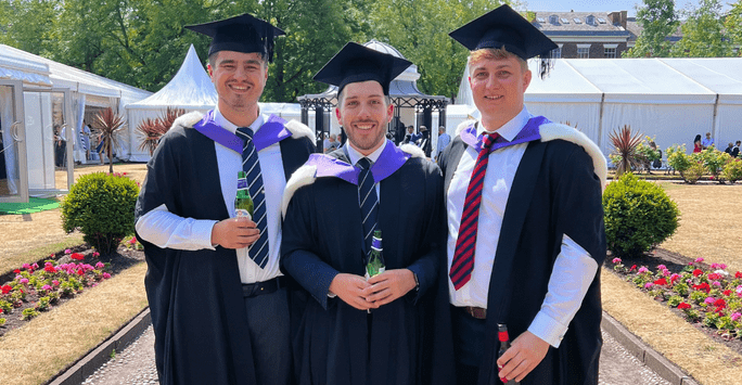 Charlie and two friends on their graduation day