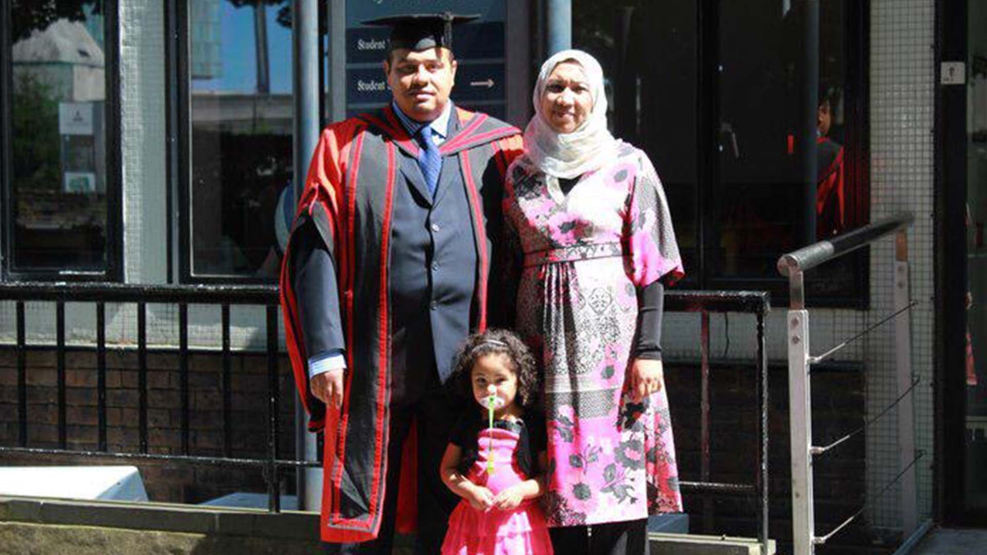 three people pose for a photo