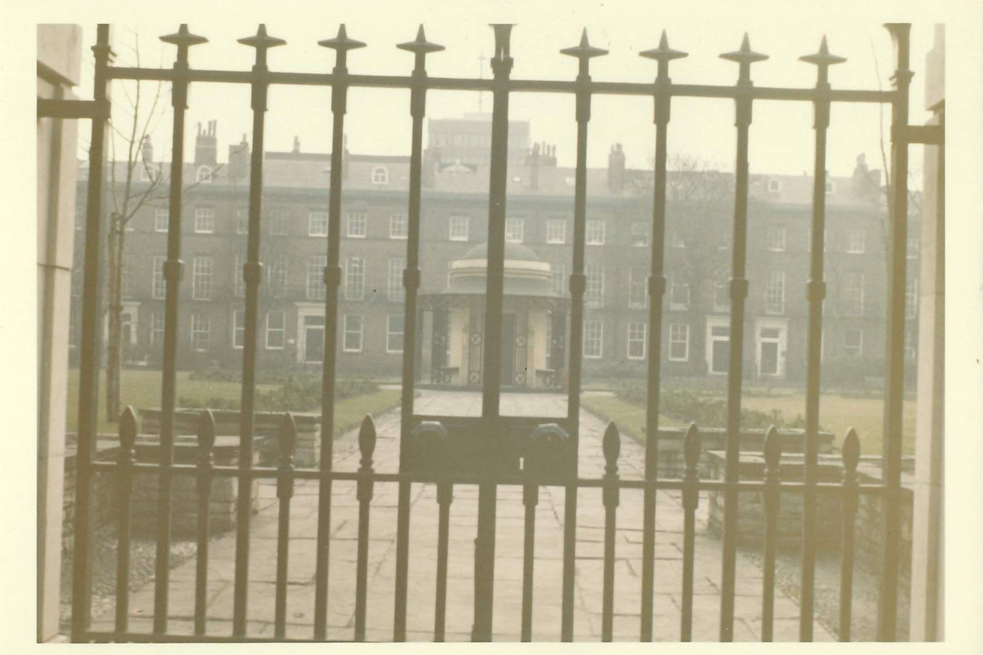 image of gardens behind gates