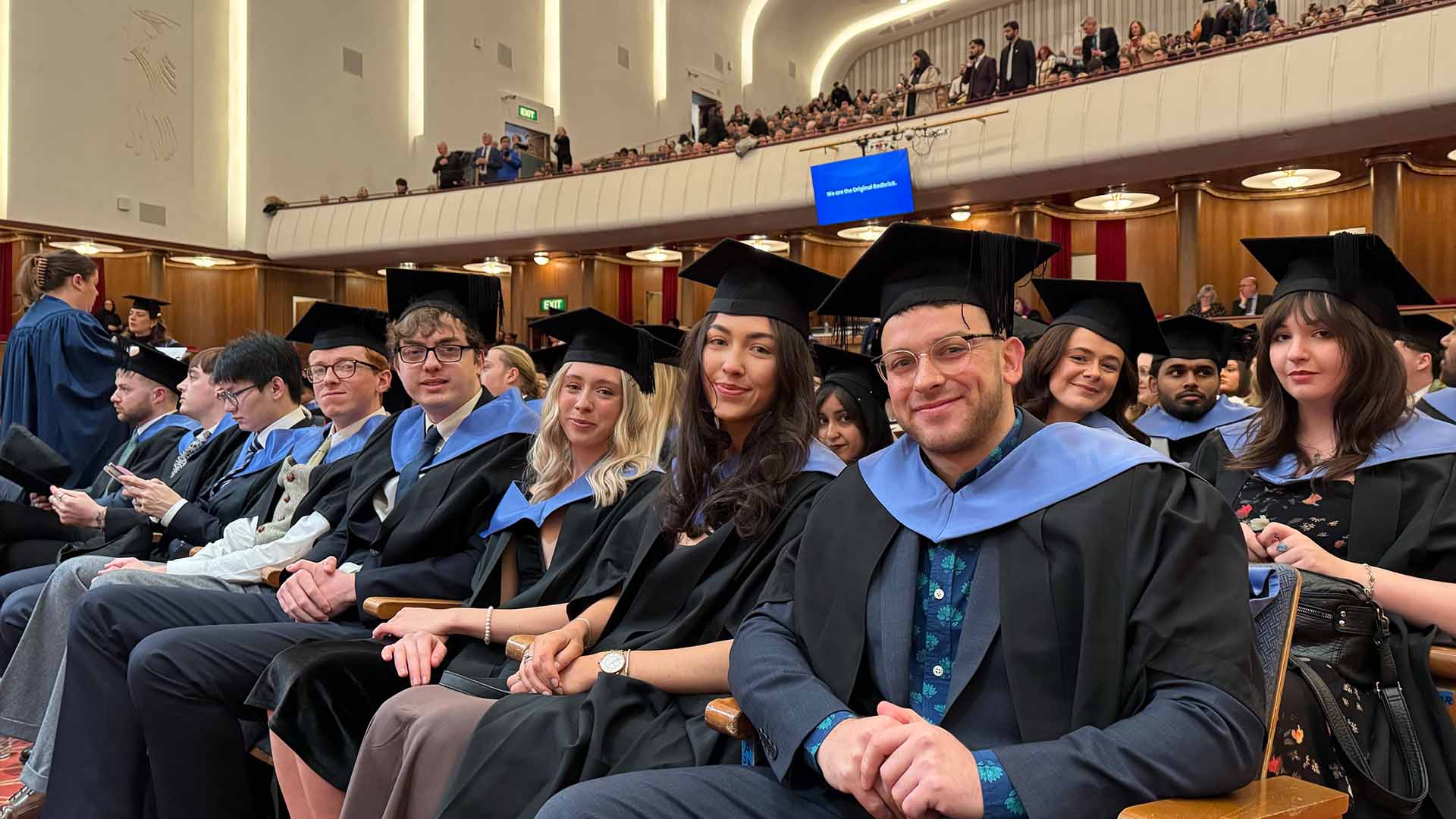 Graduates sit in auditorium waiting to graduate