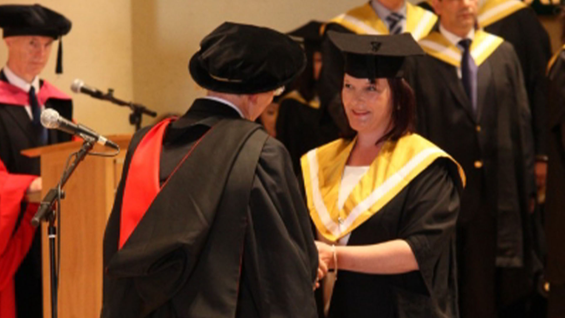 Graduate receiving their degree on stage