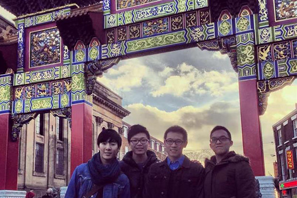 Group of people stood in front of an arch