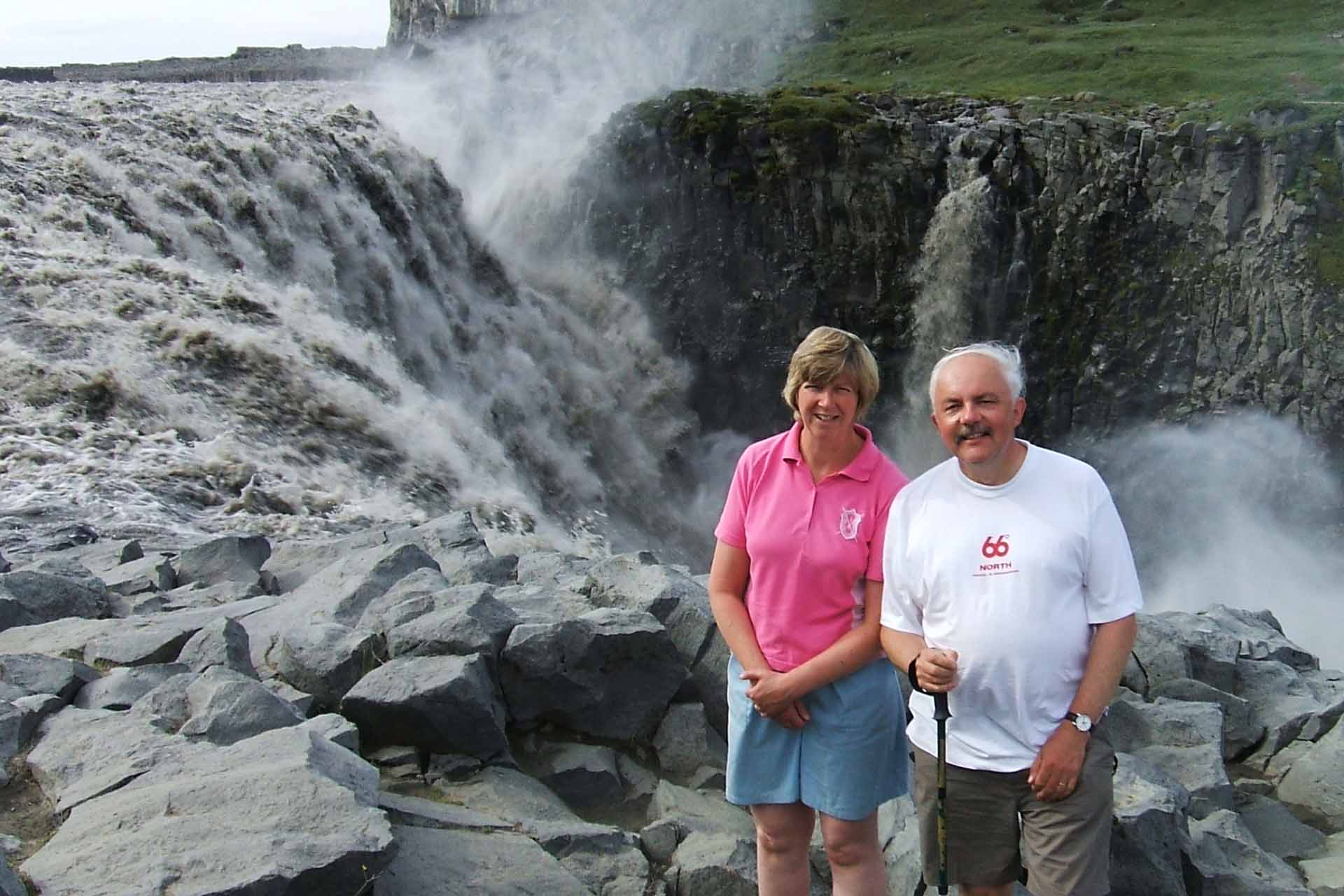 Two people by a volcano