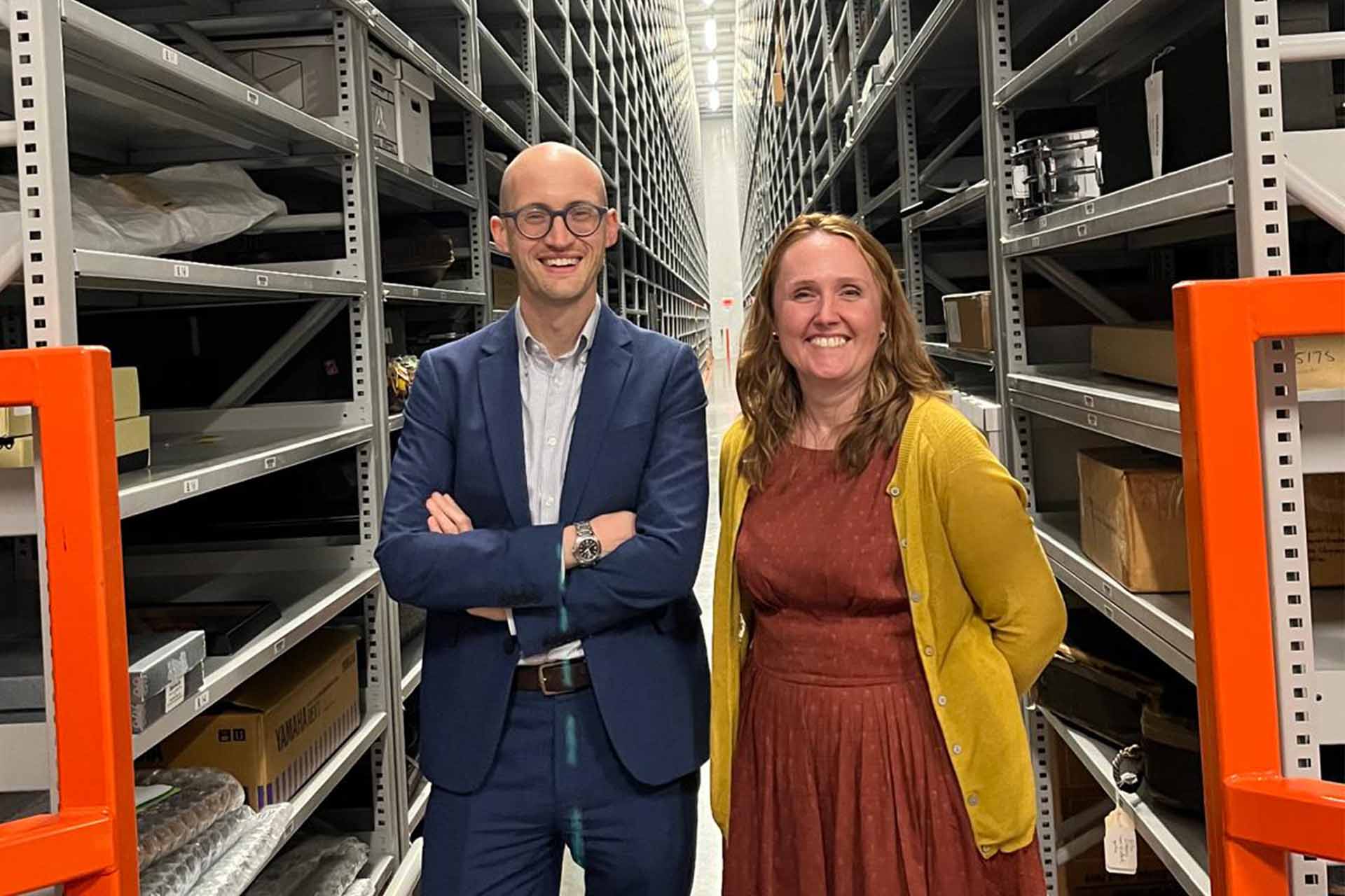 Two people stood in a library collection