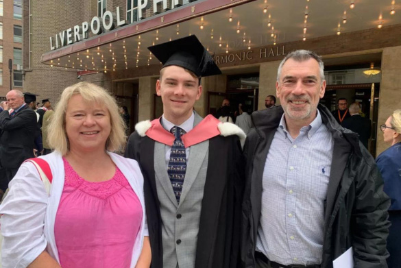 Graduate with family on graduation day