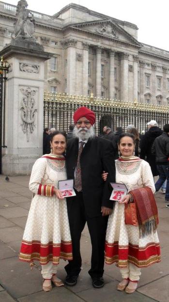 two women and man outside palace