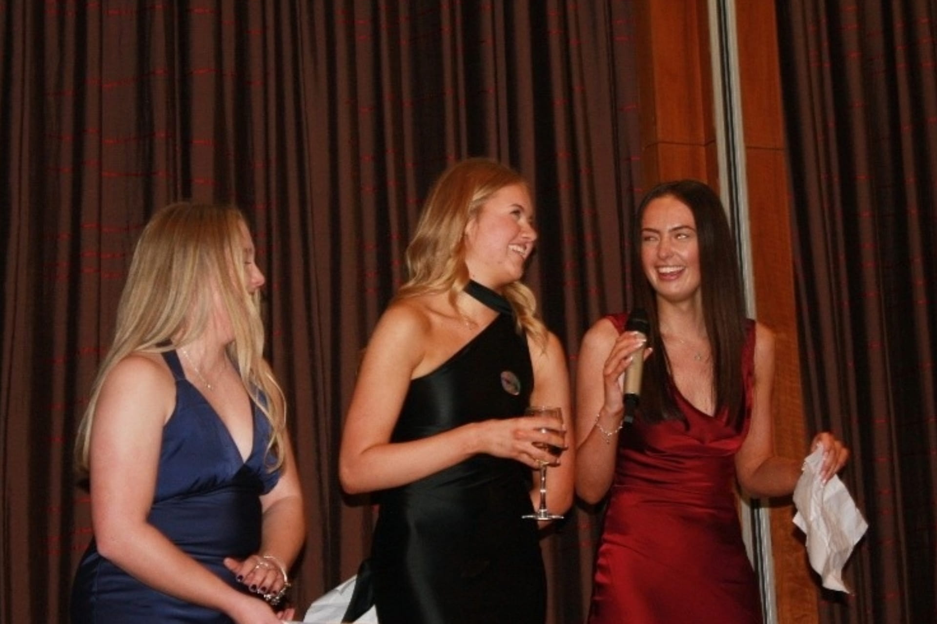 Three people at a dinner event