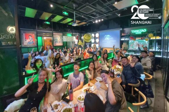 Large group of people at a bar/restaurant in Shanghai taking a photo