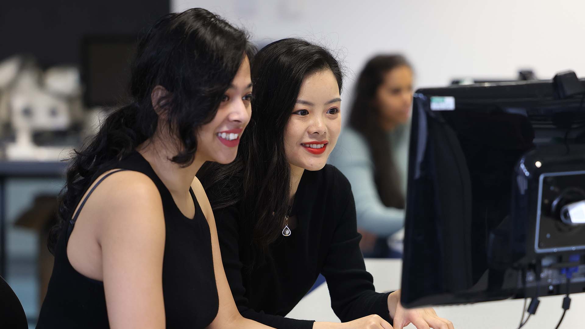 Two people looking at a computer