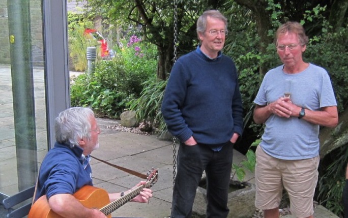 Alumni Neill Fozard, John McCall and Rod Andrew, who has a guitar in hand, meet up for reunion