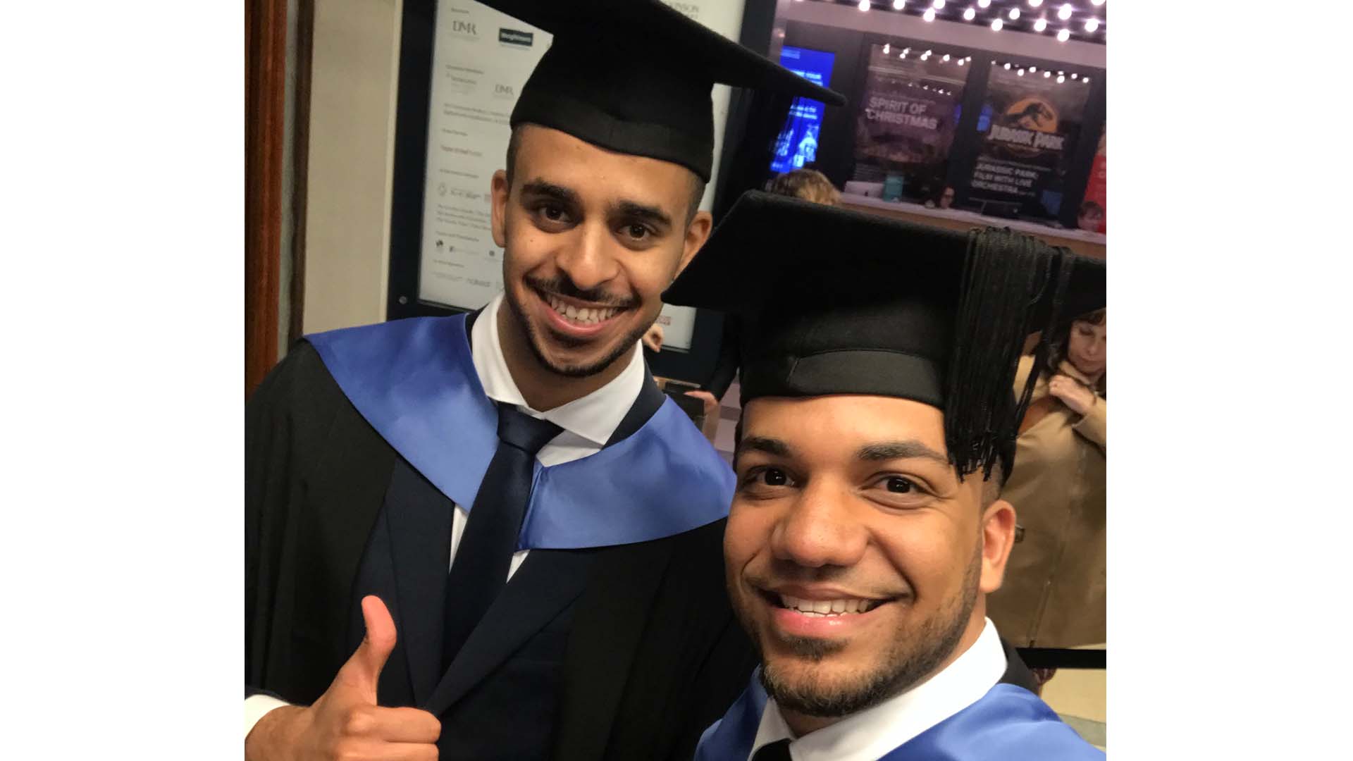 Two graduates pose for a photo