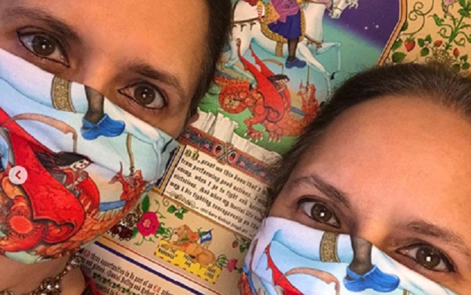 The Singh Twins in face masks which feature their artwork.