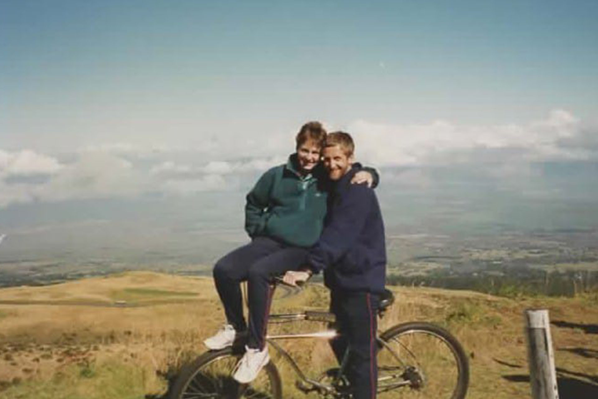 Two people on a mountain on a bike