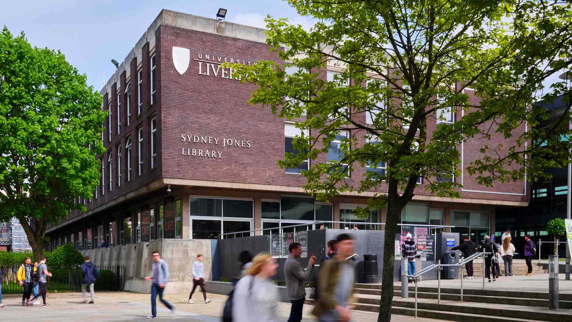 Image of a library building with students walking past