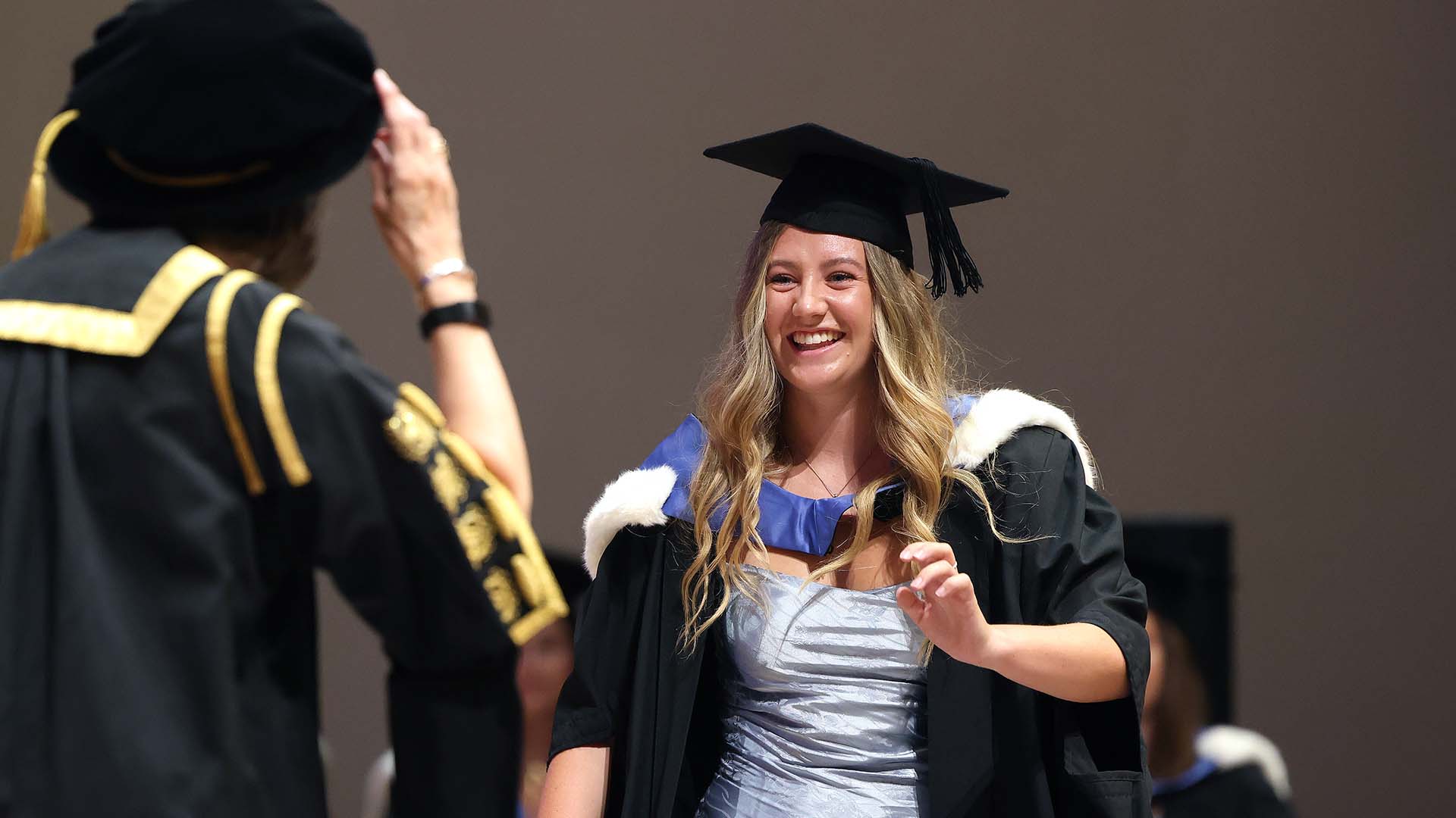 Graduating student walking across a stage