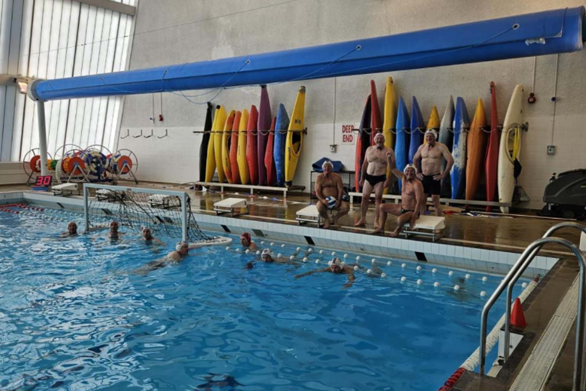 Group of people in a pool playing waterpolo