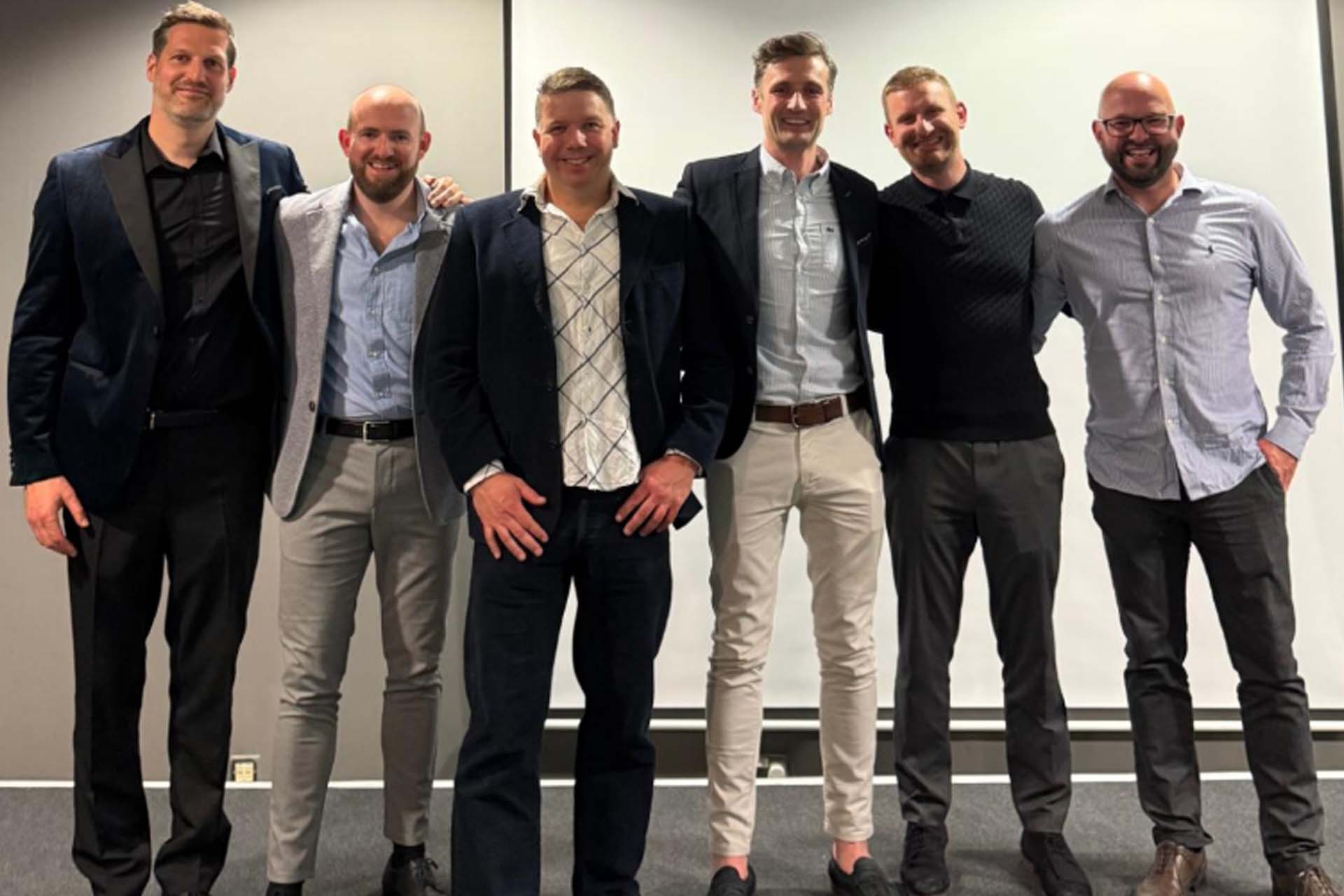 six people posing for a photograph
