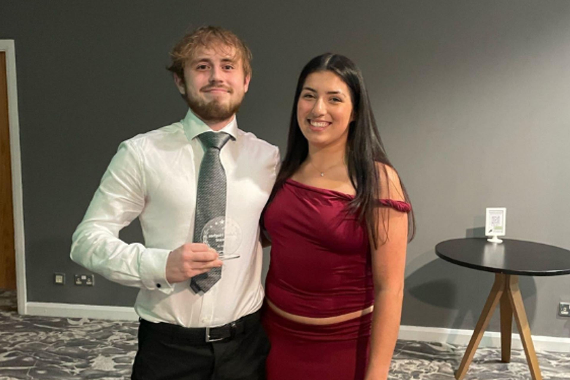 Two people pose for a photograph