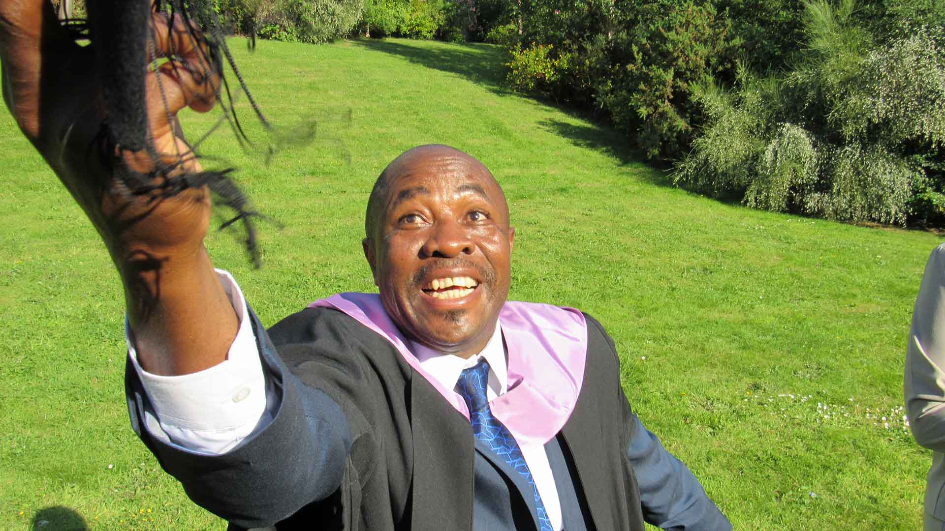 Graduate throwing hat in the air