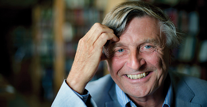 Man in a blue shirt smiling at the camera