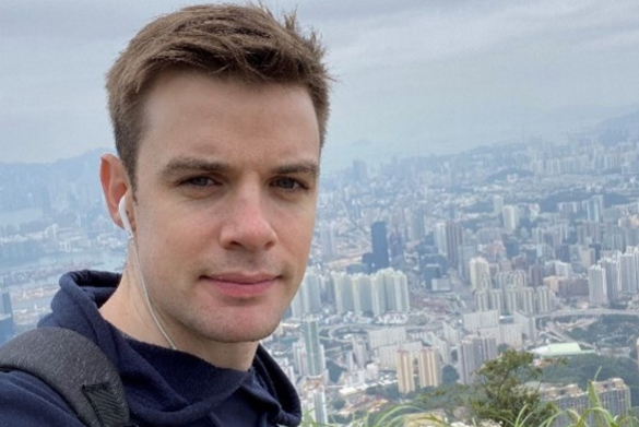 Student taking selfie with city landscape in background