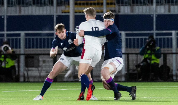Three rugby players during a game