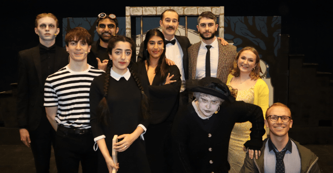 performers dressed as the Addams Family