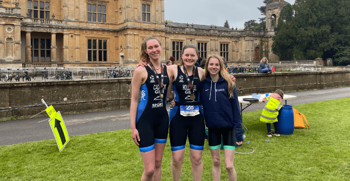 three athletes at a triathlon event