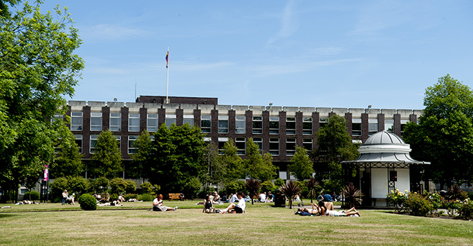 Students sitting in Abercromby Square with Sydney Jones Library in the background
